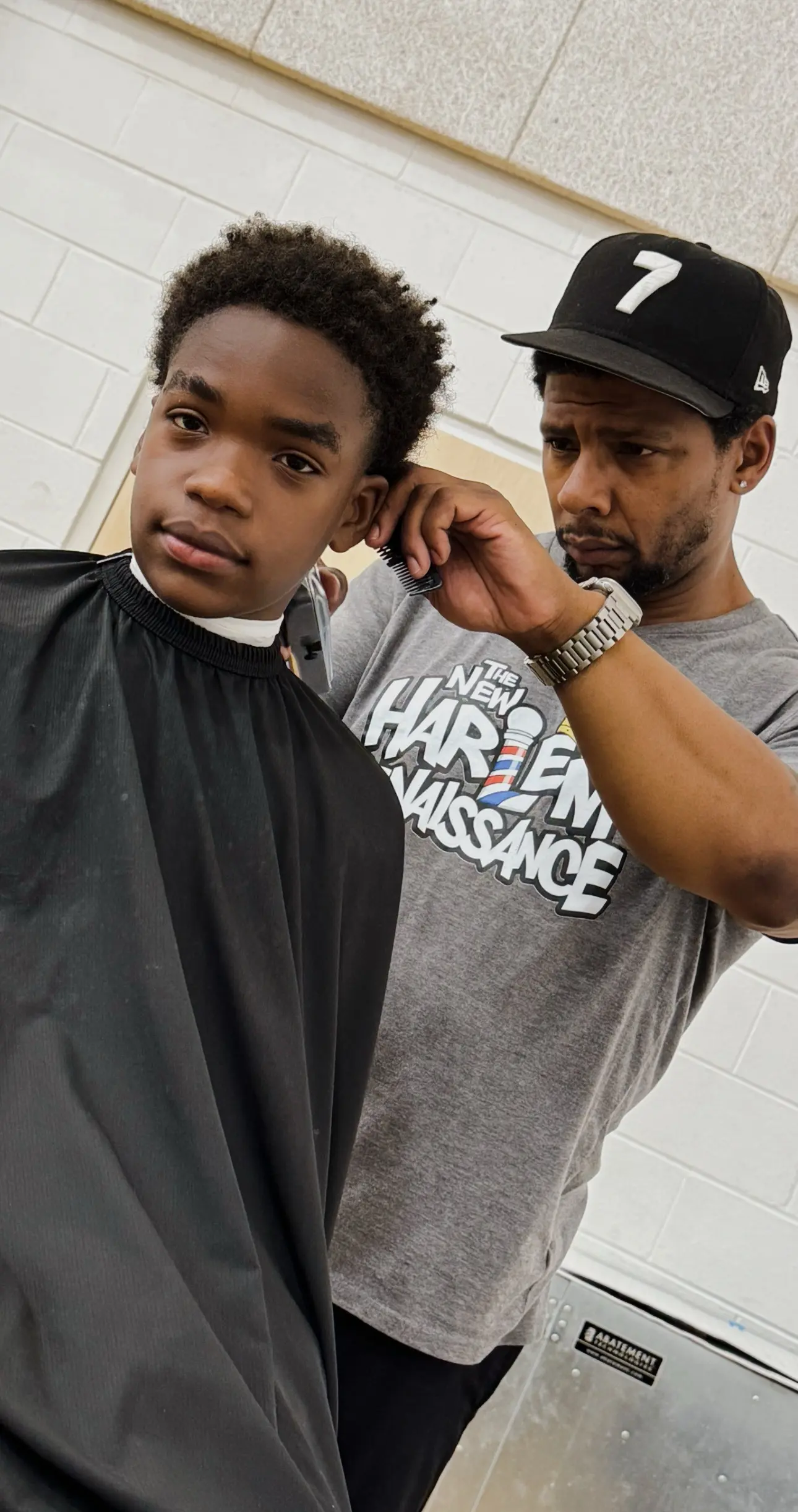 Kennard cutting a student’s hair