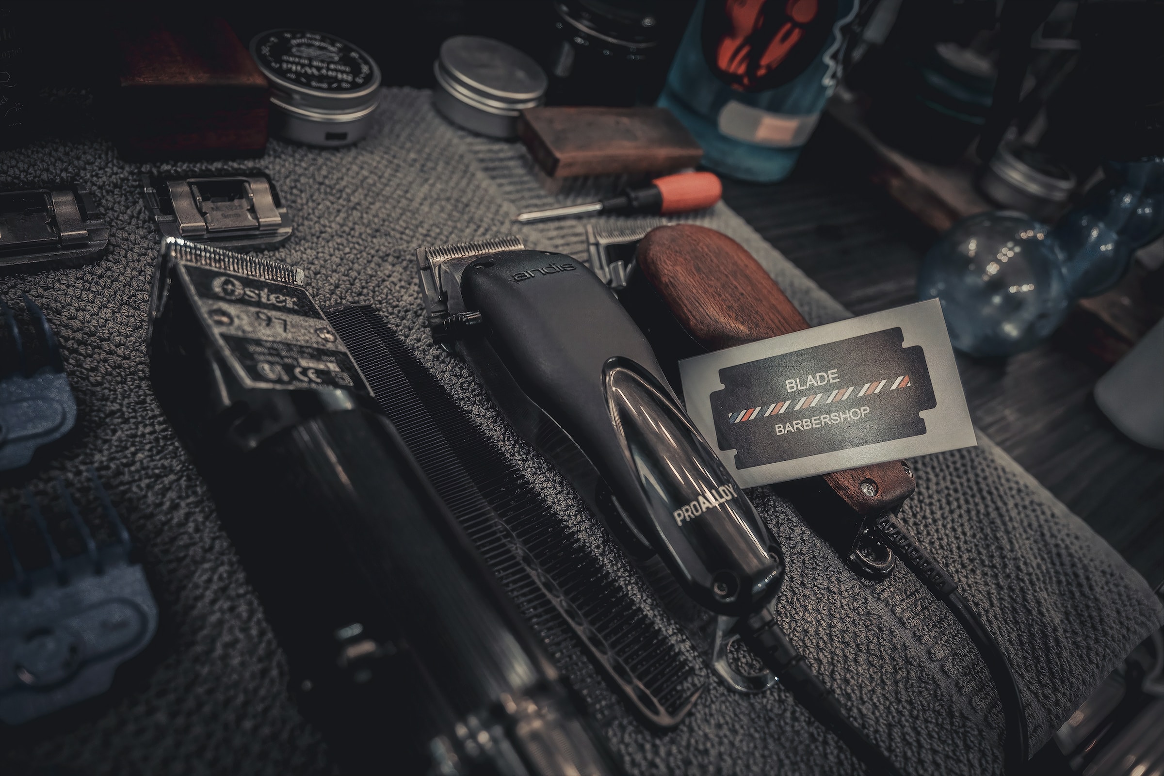 Barber's workstation with an array of clippers, grooming tools, and combs.